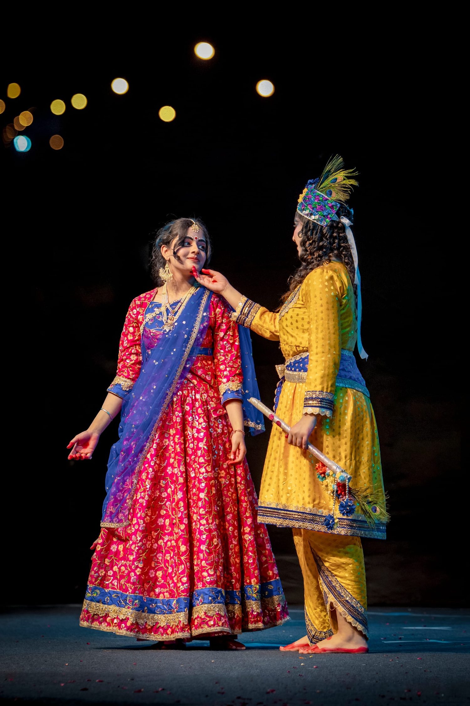 Students performing during a warmly lit school annual-day celebration
